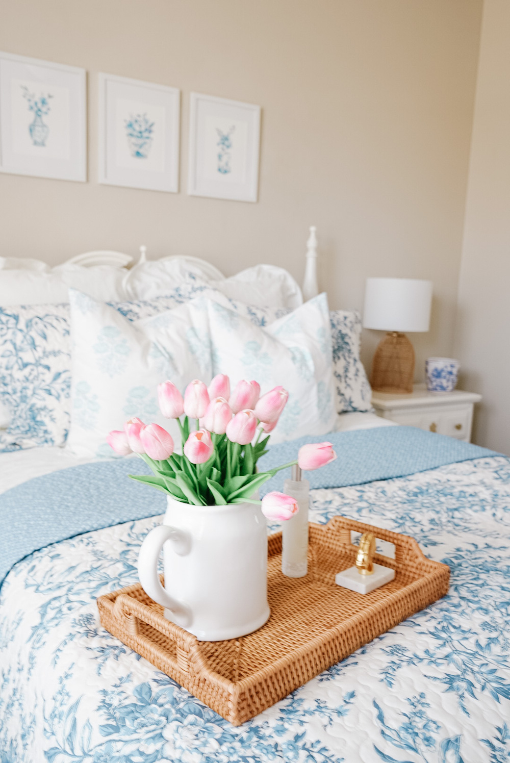 bedroom faux tulip florals in a vase on a tray on the bed