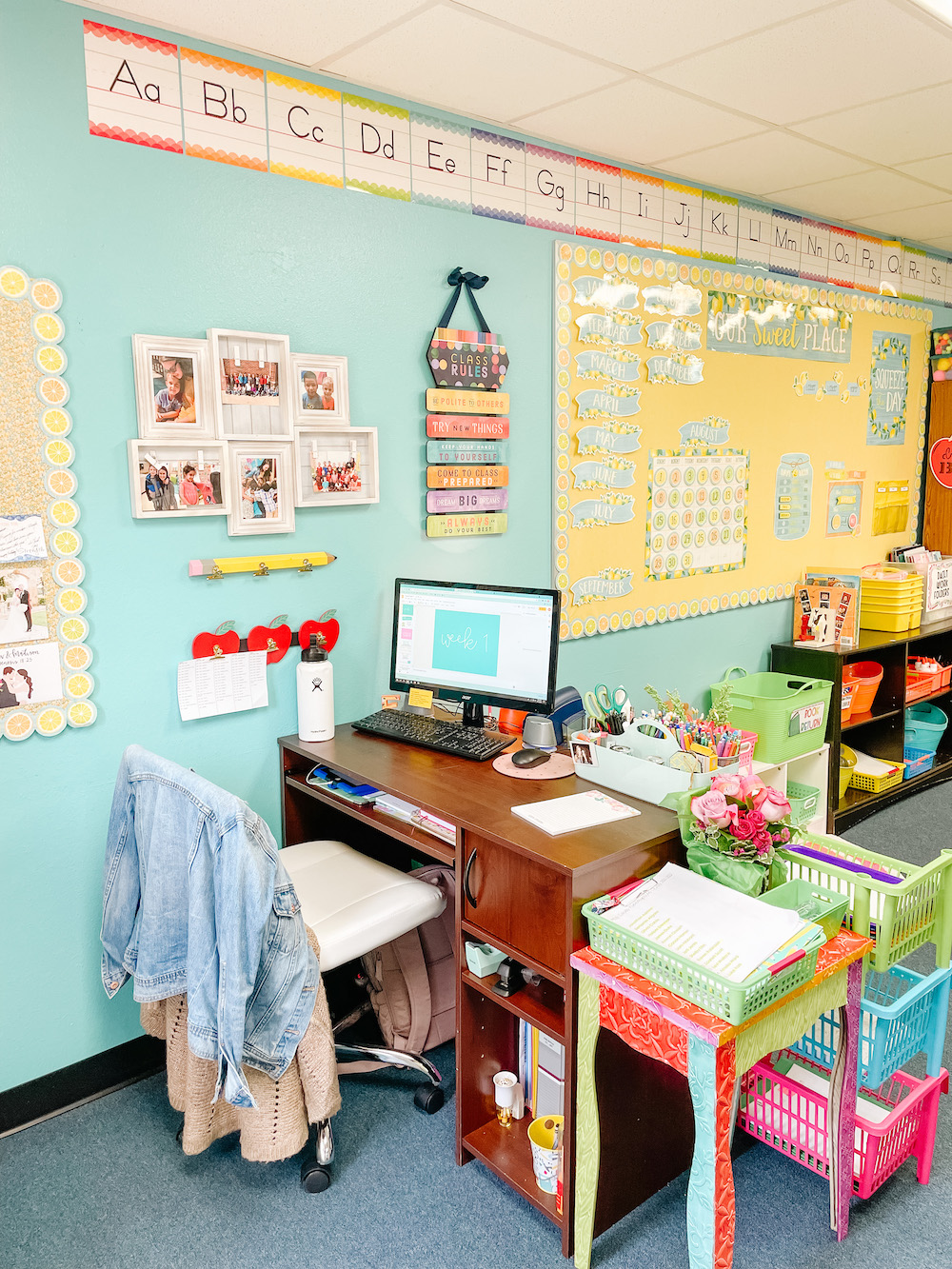Kindergarten classroom teacher desk area rainbow decor