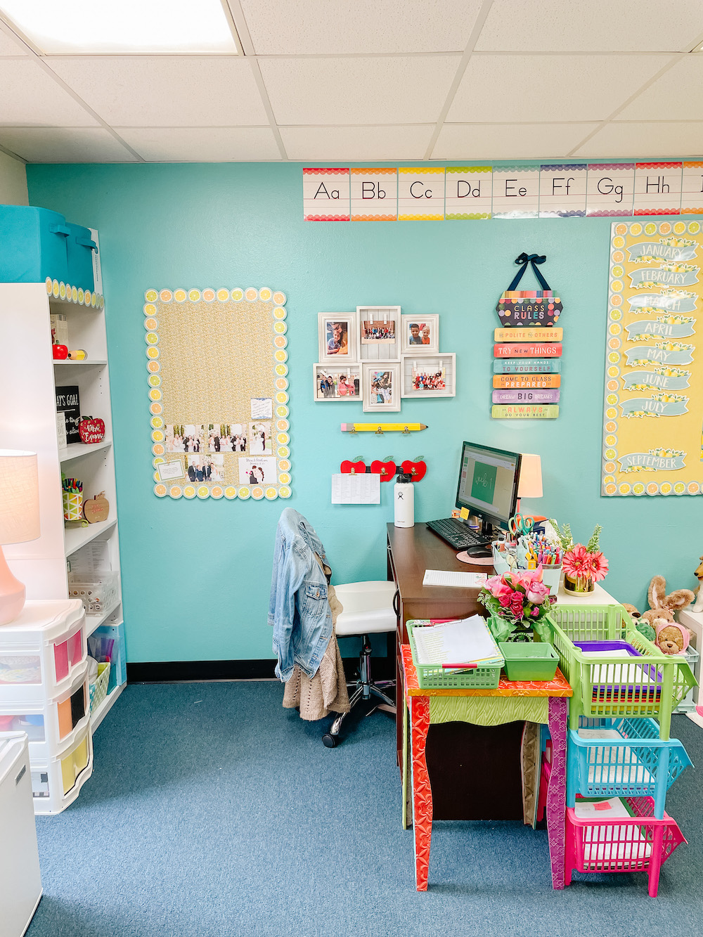Kindergarten classroom teacher desk area rainbow decor